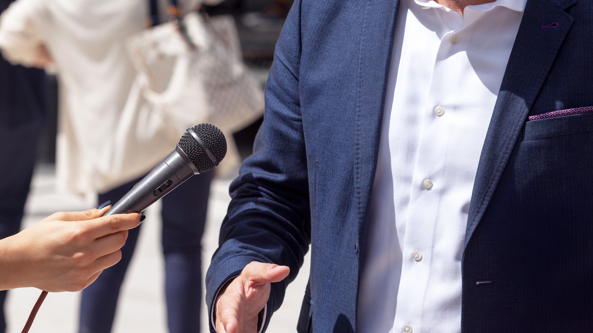 De torso van een man met een microfoon onder zijn neus - blog uitgeverij haystack